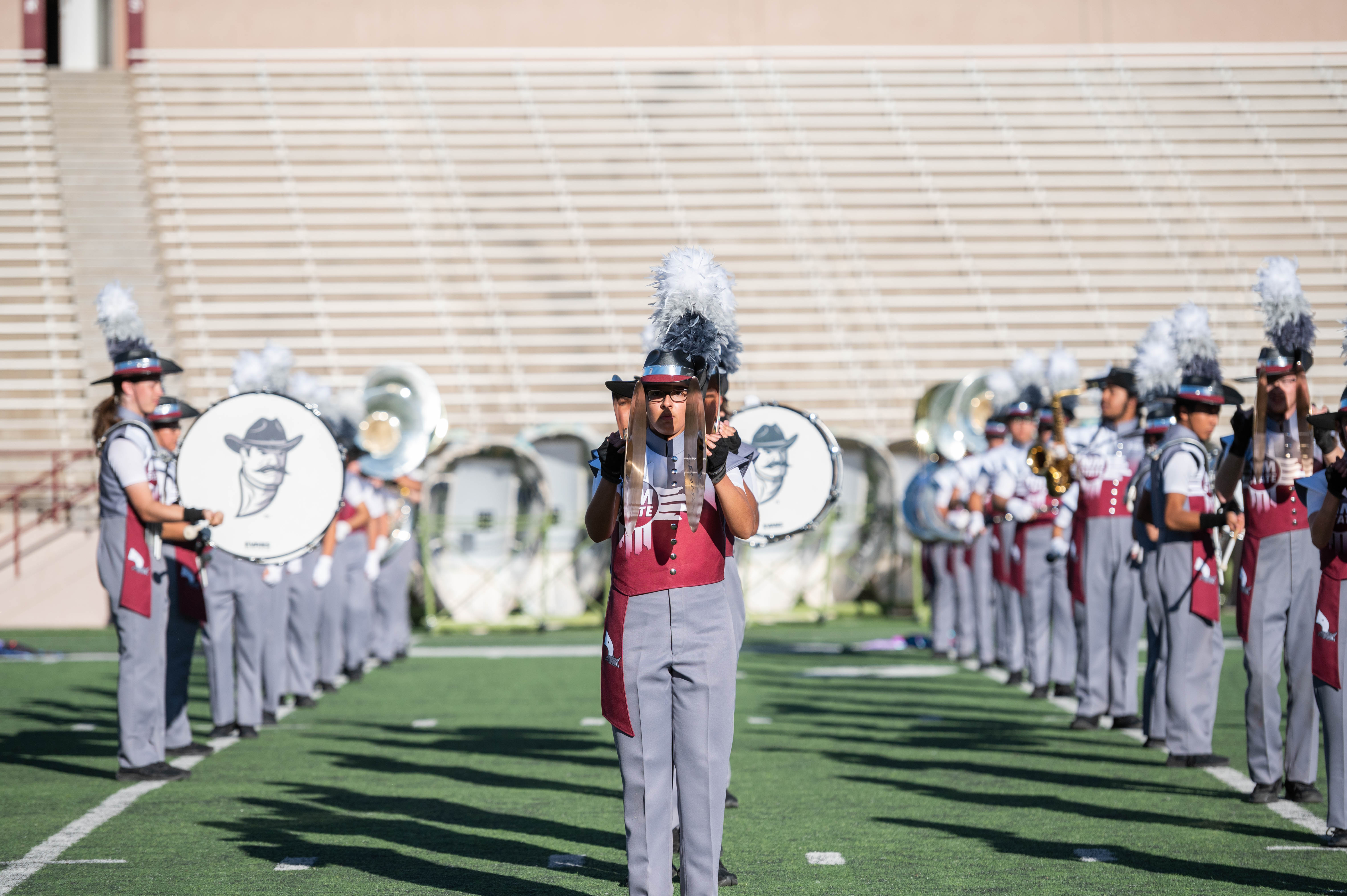 Pride of New Mexico drumline students on the field performing.